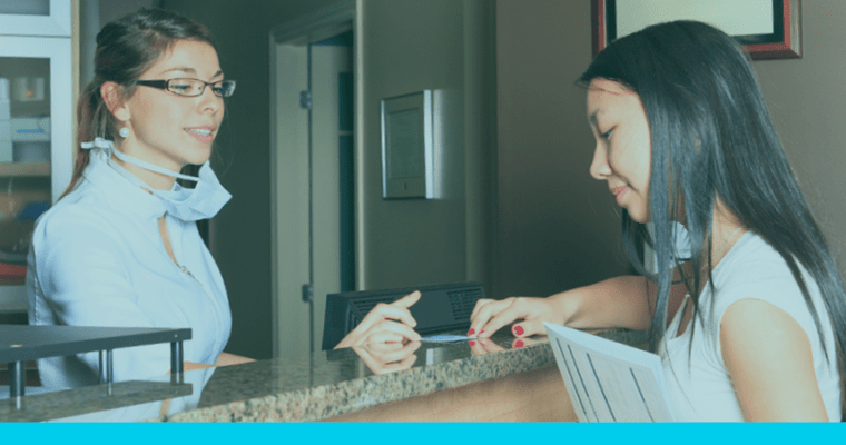 Dental office professional assisting a patient